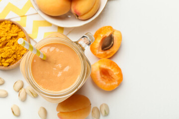 Superfood. Tasty smoothie and ingredients on white table, flat lay. Space for text