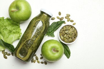 Superfood. Tasty smoothie in glass bottle and ingredients on white table, flat lay