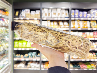 choosing spaghetti in a supermarket	
