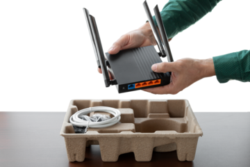 Man's hands holding new wifi router on isolated background. Unpacking new router.