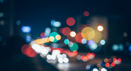 Colorful abstract background of blurred city traffic lights at night.