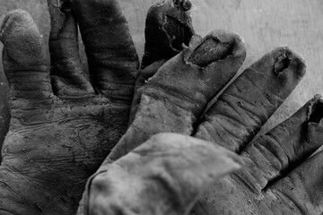 Old work gloves used for labor closeup of vintage texture.