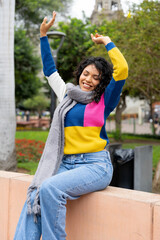Young latin american woman enjoying a beautiful day in the city