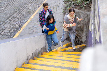 Young friends running up stairs in the city