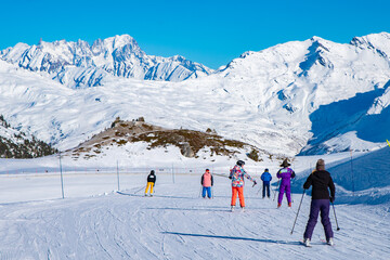 People  enjoy ski and snowboard for winter holiday in Alps area with Mont Blanc as background, Les...