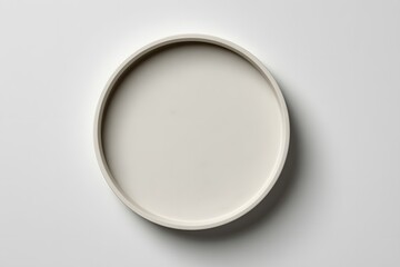 Minimalist Round White Plate on Light Gray Surface for Modern Tableware and Food Presentation