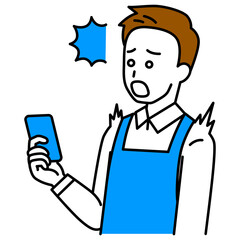スマートフォンの画面を見て驚くエプロン姿の男性