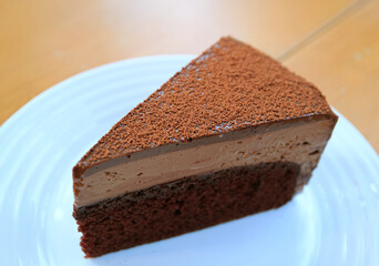 A Slice of Flavorful Chocolate Mousse Cake Served on Wooden Table