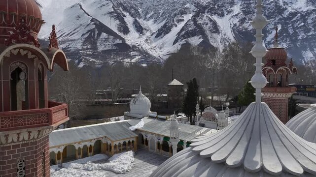 Aerial view of Chitral Central Mosque in Winter in Khyber-Pakhtunkhwa, Chitral, Pakistan. White Domes in sunny day