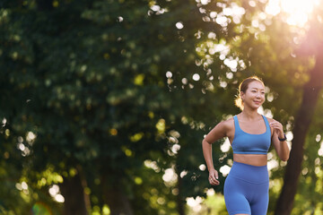 Active Woman Jogging Outdoors in a Green Park during Sunny Day