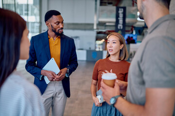 Business colleagues having informal conversation during a coffee break, sharing ideas and updates