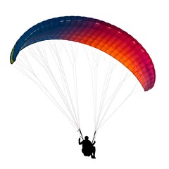 Paraglider with colorful canopy soaring against a white background isolated on white background