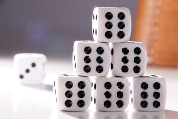 A random arrangement of dice and a puzzle cup, captured after the dice have been cast.