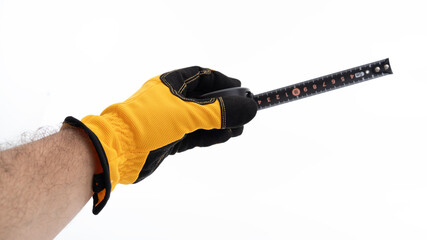 Measuring tool held by gloved hand indoors