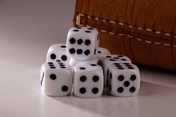 A random arrangement of dice and a puzzle cup, captured after the dice have been cast.