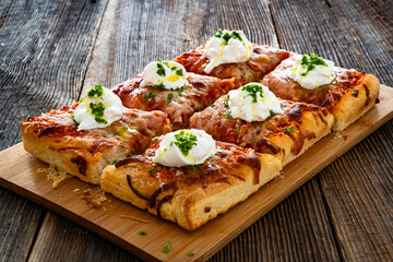 Pizza al metro margherita with burrata cheese on wooden table