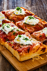 Pizza al metro margherita with burrata cheese on wooden table