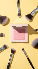 Pastel Pink Blush Compact Surrounded by Makeup Brushes on Yellow Background