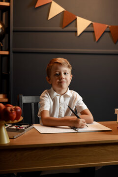 Child Doing Homework with Books and Globe &ndash; Back to School Theme