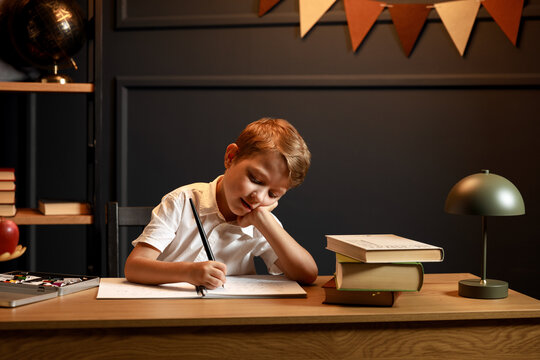 Child Doing Homework with Books and Globe &ndash; Back to School Theme