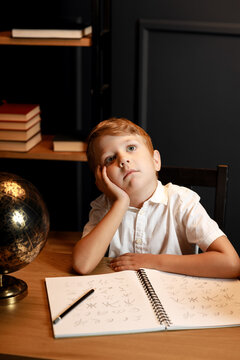 Child Doing Homework with Books and Globe &ndash; Back to School Theme