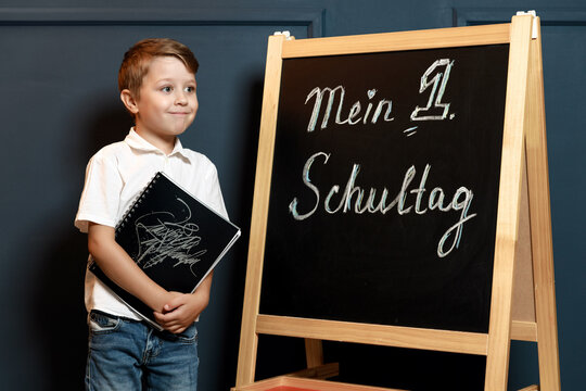 Child Doing Homework with Books and Globe &ndash; Back to School Theme