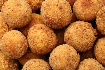 Delicious fried croquette balls as background, top view