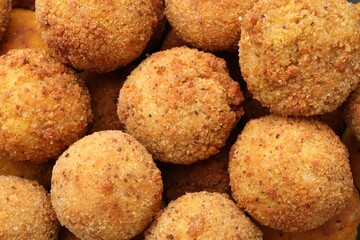 Delicious fried croquette balls as background, top view