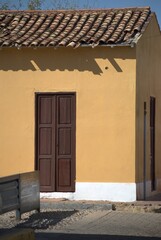Fototapeta premium Sometimes modern and thriving, sometimes rural and colonial, houses made from the same land still prevail, as well as the modern use of concrete.