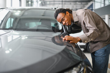 African american Man buying a car at a showroom