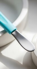 Teal-Handled Spatula: Minimalist Kitchen Still Life with Soft Light and Shadows
