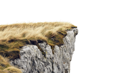 Rocky cliff edge with dry grass on top, isolated on transparent cutout background