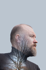 Profile of man with silhouette of bare tree, expressing connection to nature