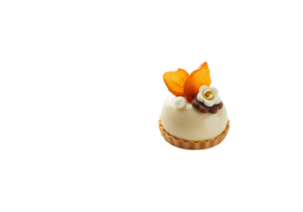 A Delicate Petit Four Creamy White Icing Caramel Accents and Orange Blossom Garnish