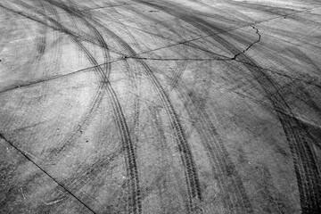 Black Tire Tracks Marks on Cement Drive