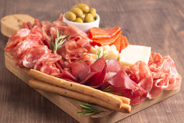 Charcuterie board. Antipasti appetizers of meat platter with salami, prosciutto crudo or jamon and olives.