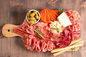 Charcuterie board. Antipasti appetizers of meat platter with salami, prosciutto crudo or jamon and olives.