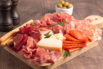 Charcuterie board. Antipasti appetizers of meat platter with salami, prosciutto crudo or jamon and olives.