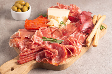 Charcuterie board. Antipasti appetizers of meat platter with salami, prosciutto crudo or jamon and olives.