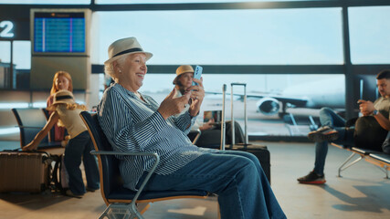Senior tourist woman using mobile phone in airport lounge