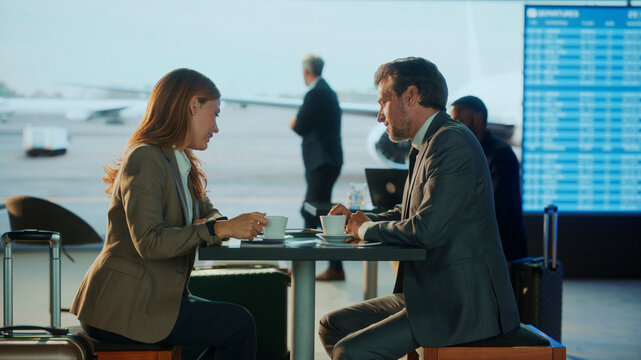 Business people having coffee at airport lounge while waiting for flight departure