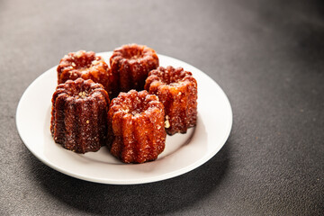 Canneles sweet dessert french cuisine sweets fresh delicious gourmet food background on the table rustic food top view copy space