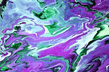 Abstract background of acrylic paint in blue, purple and green tones.