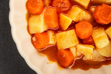 Stewed potatoes with carrots vegetarian side dish fresh delicious gourmet food background on the table rustic food top view copy space keto and paleo diet vegan food