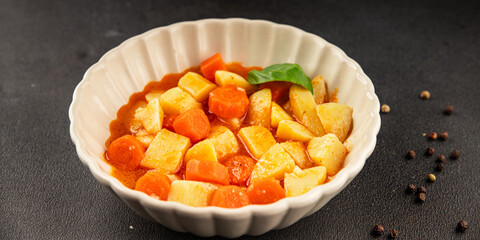 Stewed potatoes with carrots vegetarian side dish fresh delicious gourmet food background on the table rustic food top view copy space keto and paleo diet vegan food