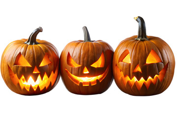 Three carved jack o lanterns with glowing faces are arranged together, isolated on a transparent background