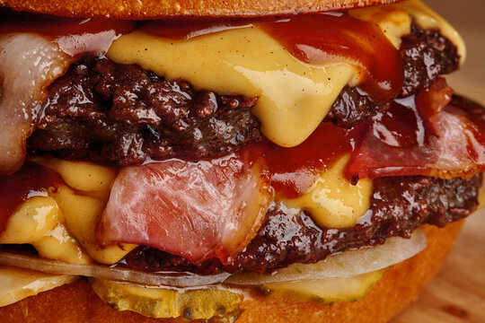 Delicious burger dripping with melted cheddar cheese and barbecue sauce