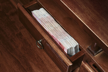 Stack of Russian rubles banknotes on box of the table. Selective focus