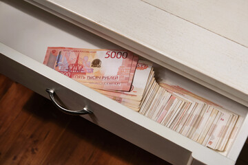 Stack of Russian rubles banknotes on the table, in the bedside table.. Selective focus