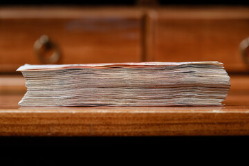 Banknotes In Stack on a wooden table. Selective focus